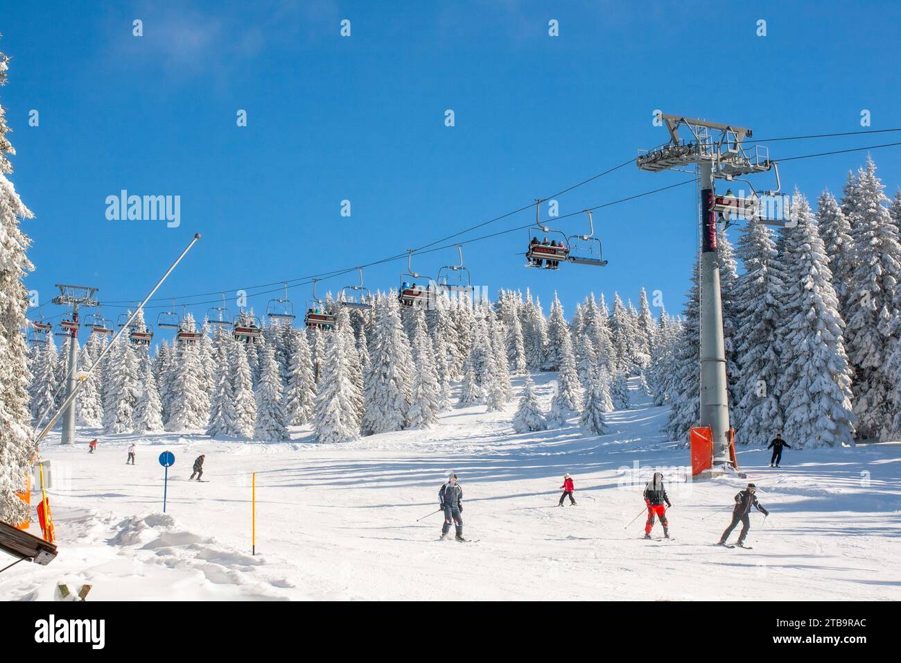 Kopaonik, Serbia - January 22, 2016: Ski resort Kopaonik, Serbia, ski slope, people on the ski lift, mountains, houses and buildings panorama Stock Photo