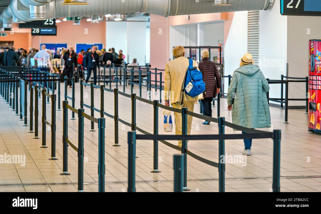 London, United Kingdom - February 05, 2019: View from back to group of passengers walking to the gate before boarding the airplane at London Luton, 5t Stock Photo