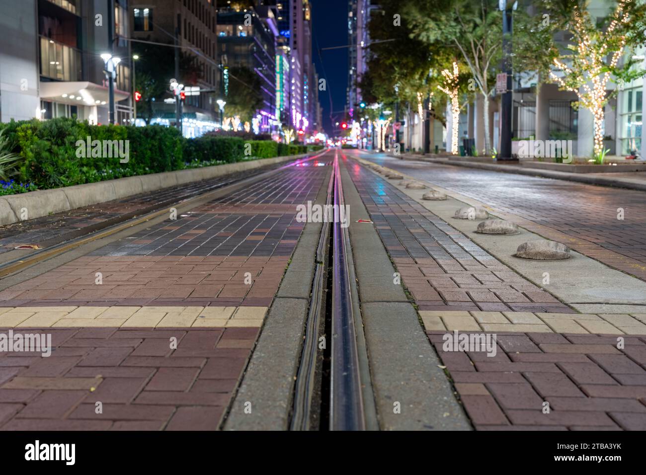 Night time photo of street car, trolly, train tracks in Houston Texas. Stock Photo