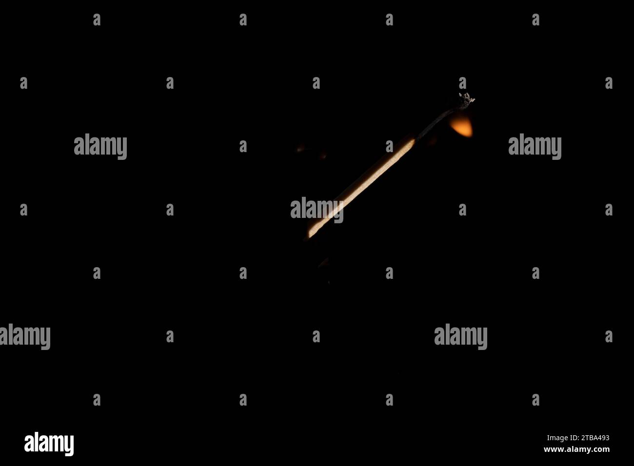 Lit and falling match on a black background. Stock Photo