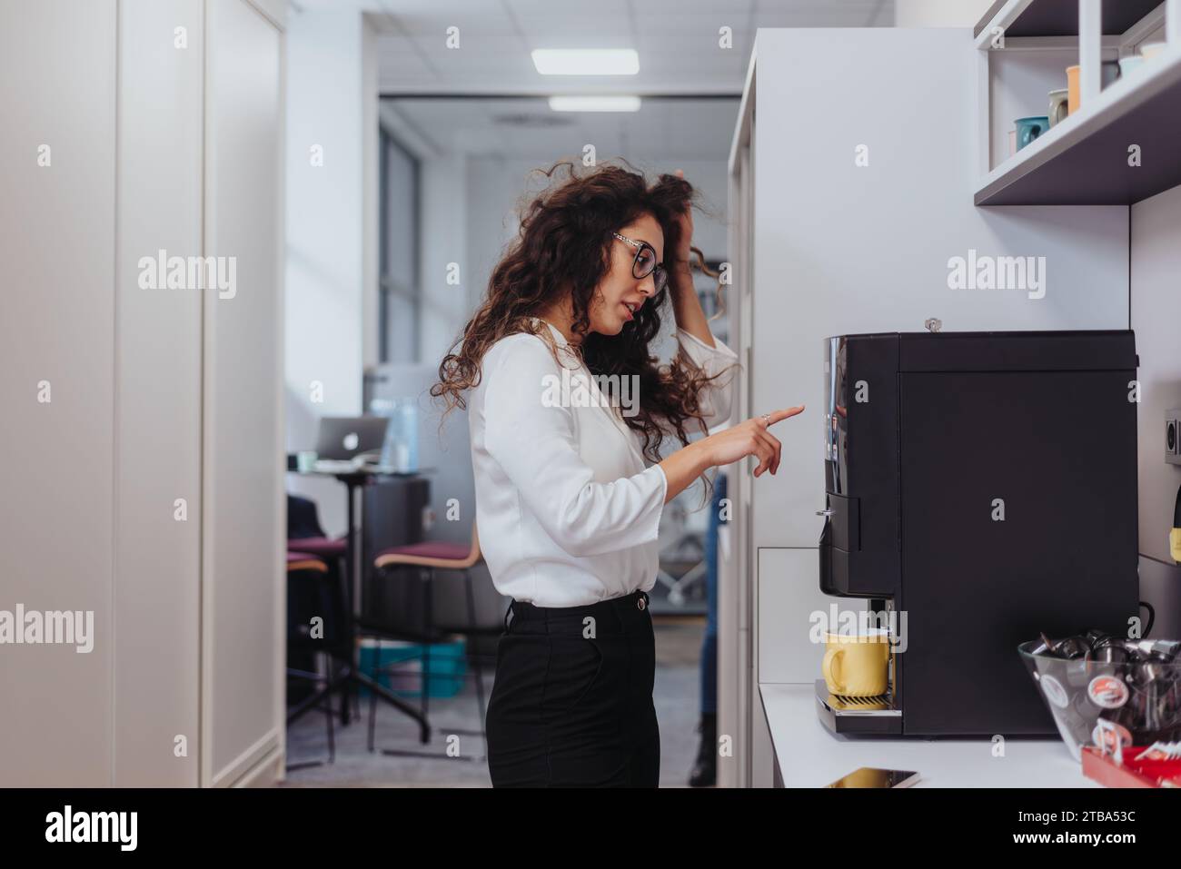 Woman making tea in office hi-res stock photography and images - Alamy