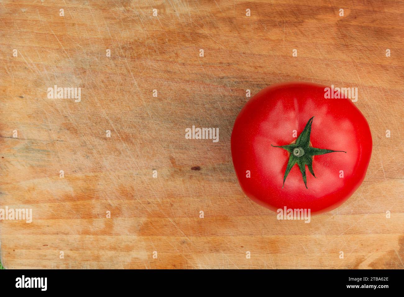 Cutting vegetables preparing salad red tomato on a wooden board Stock Photo
