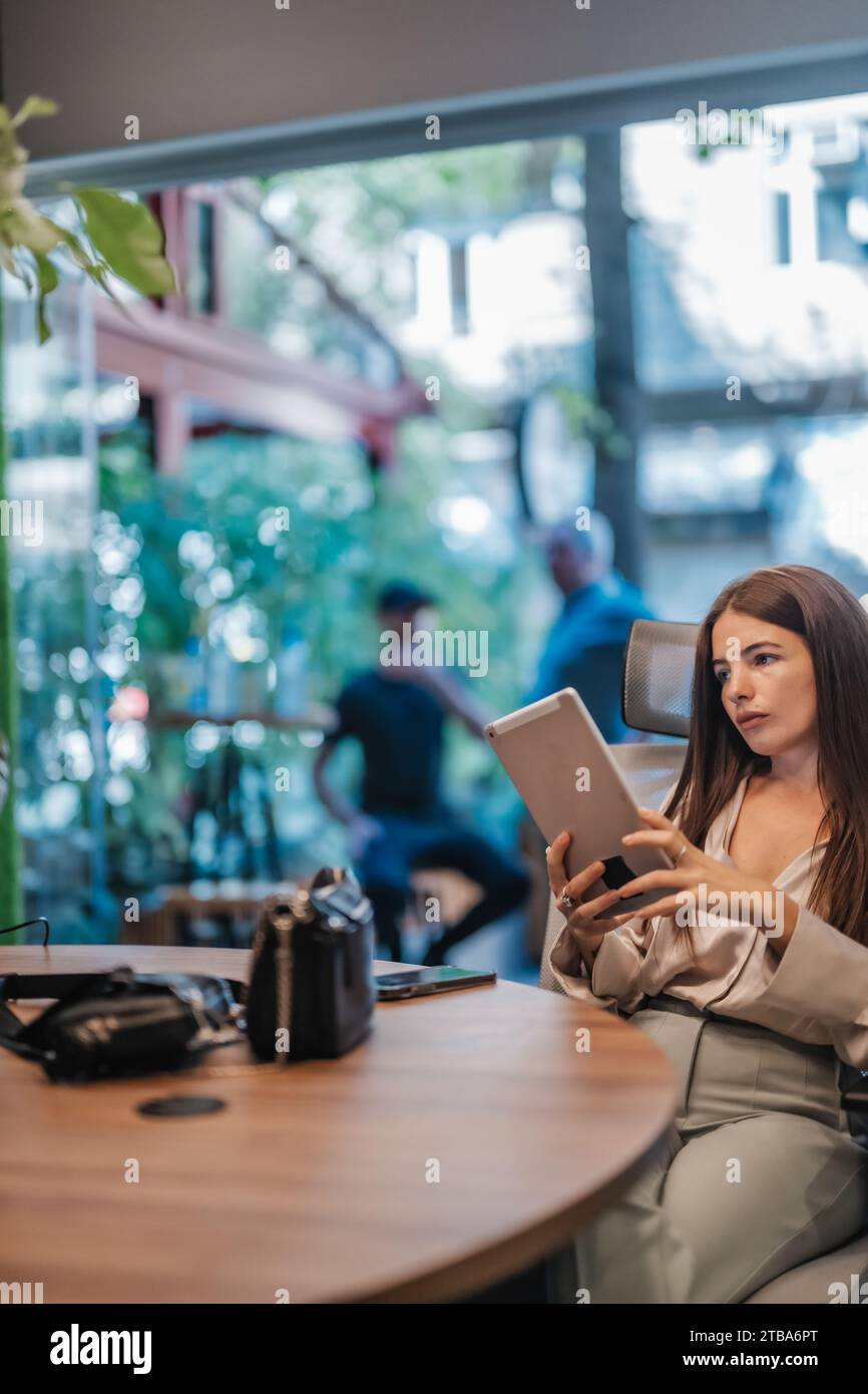 Female Entrepreneur Strategizing in Modern Downtown Office for Successful Business Growth Stock Photo