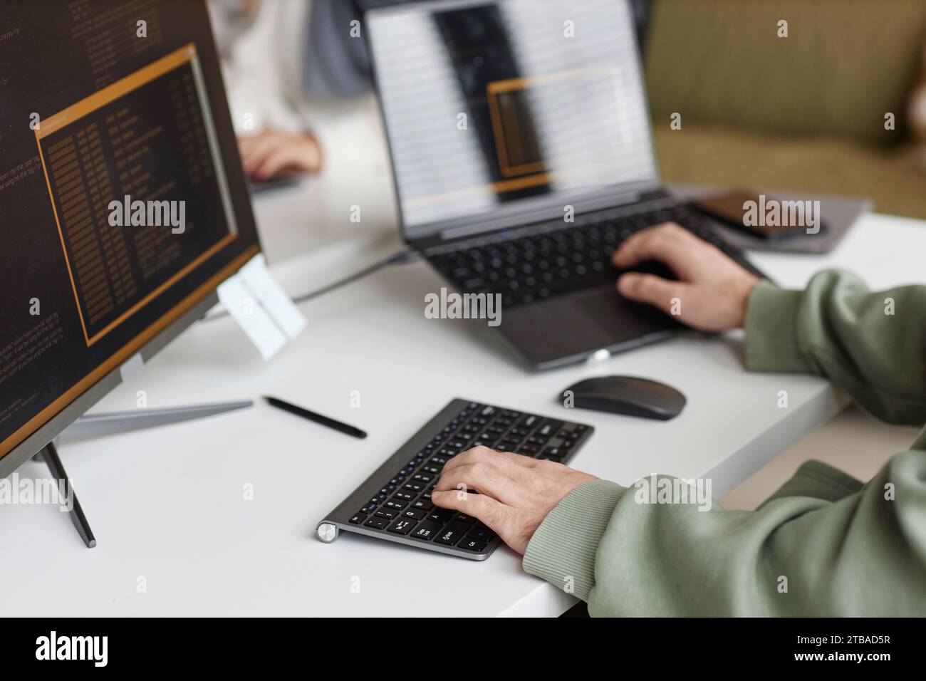 Closeup of male hands typing at computer keyboard with unrecognizable software programmer writing code, copy space Stock Photo