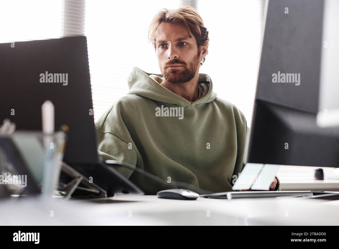 Front view portrait of bearded software developer working on IT project ... image.
