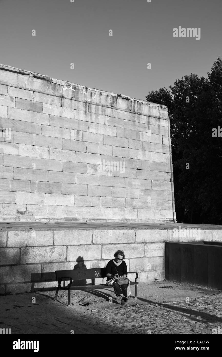 Woman sitting on a bench at the Debob Temple, Parque De La Montaña, Madrid, Spain Stock Photo