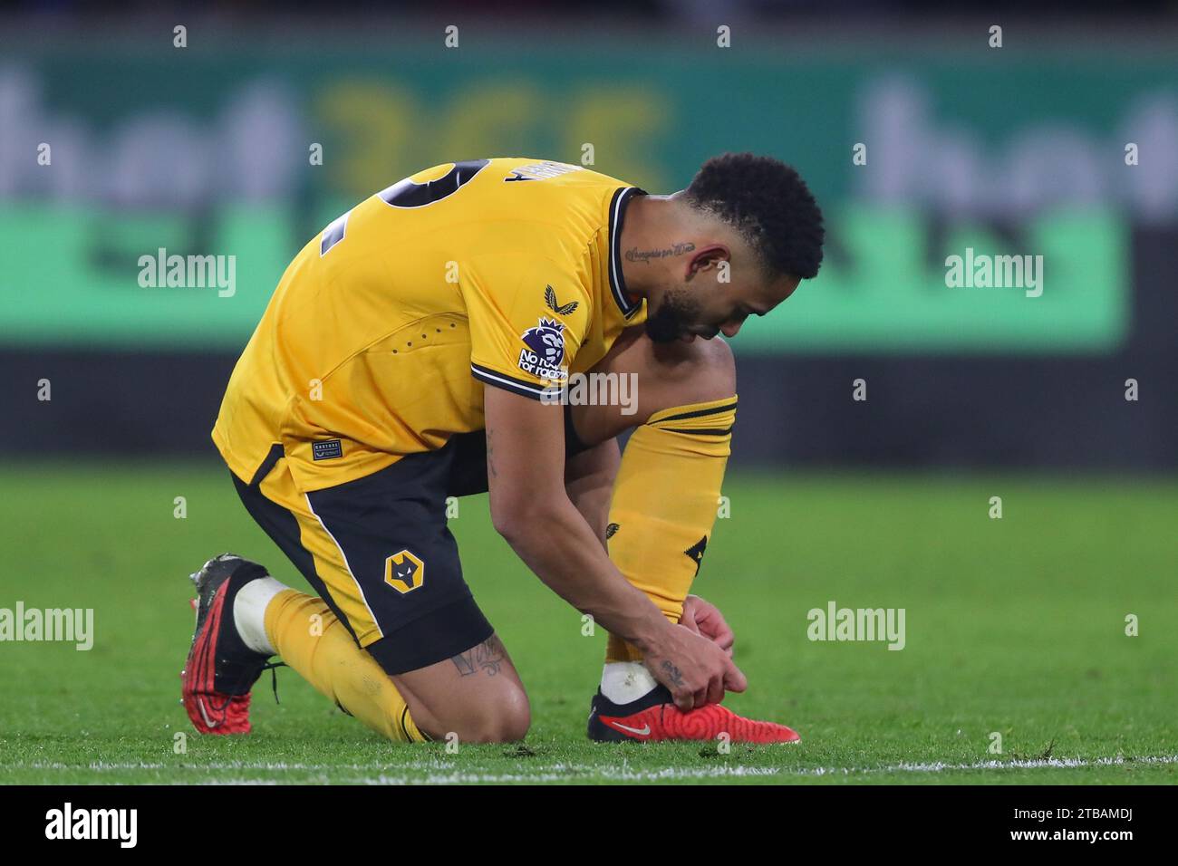 Matheus Cunha #12 of Wolverhampton Wanderers ties his laces during the