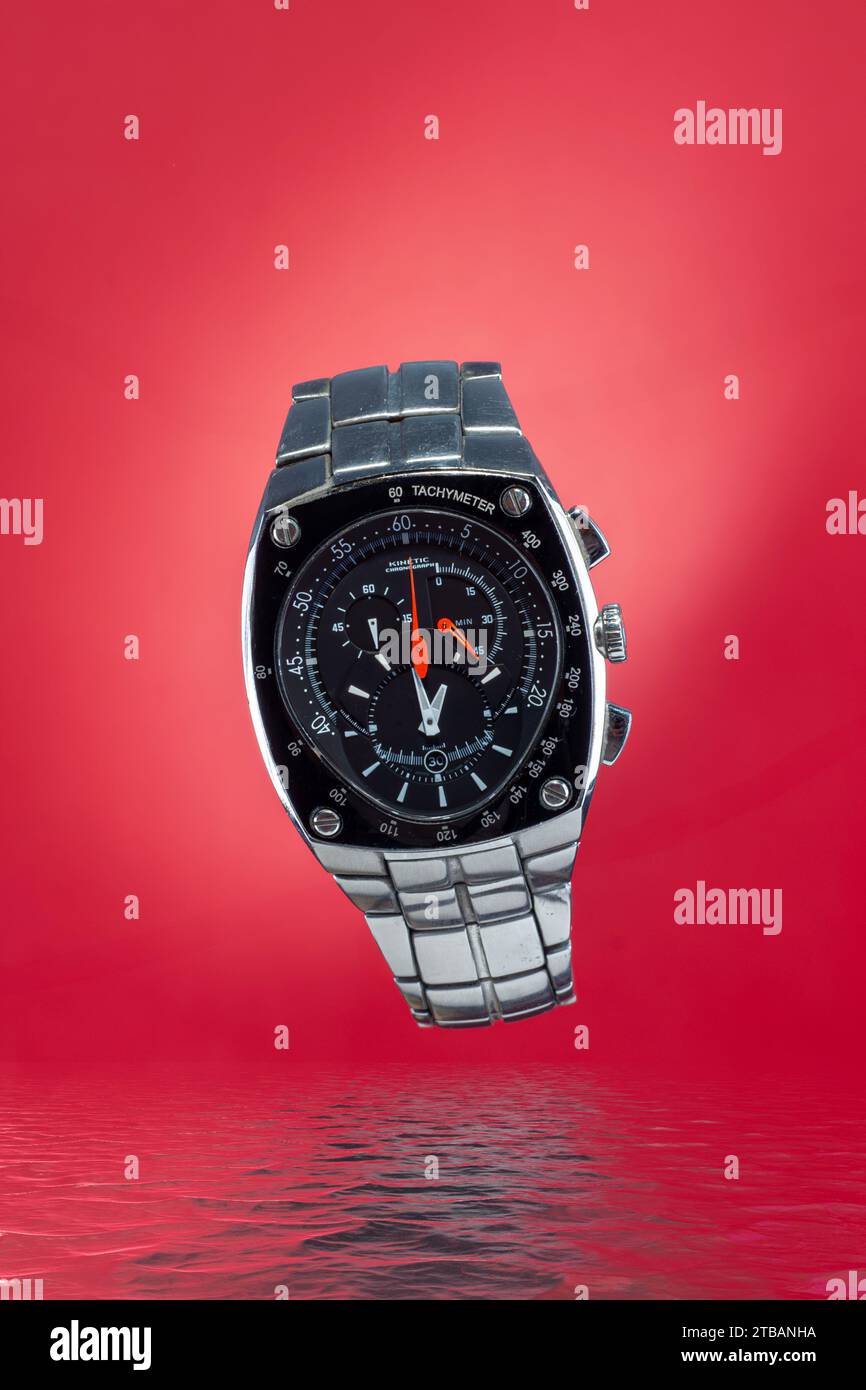 luxury watch with hands of various times, with red background and