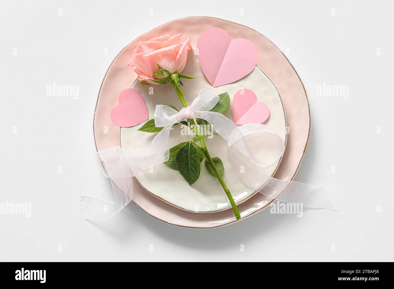Beautiful table setting with rose for Valentine's Day on white ...