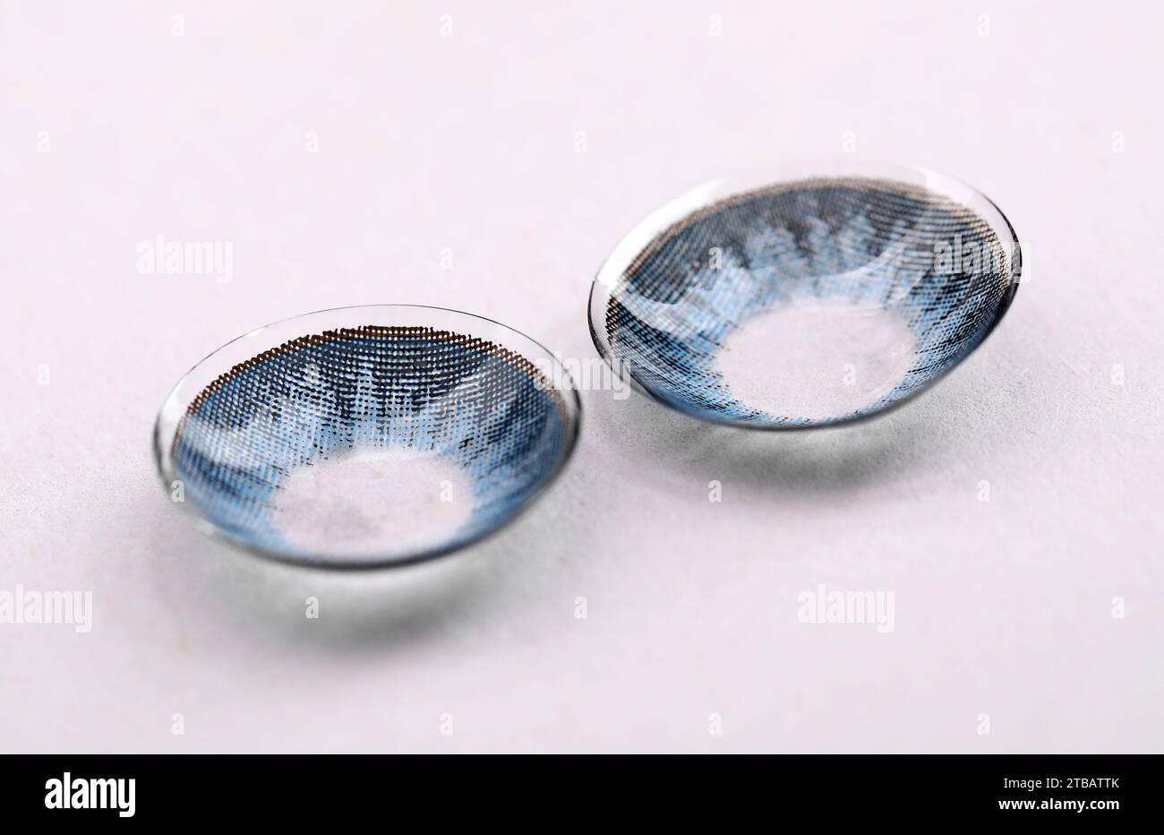 Two blue contact lenses on white background Stock Photo - Alamy