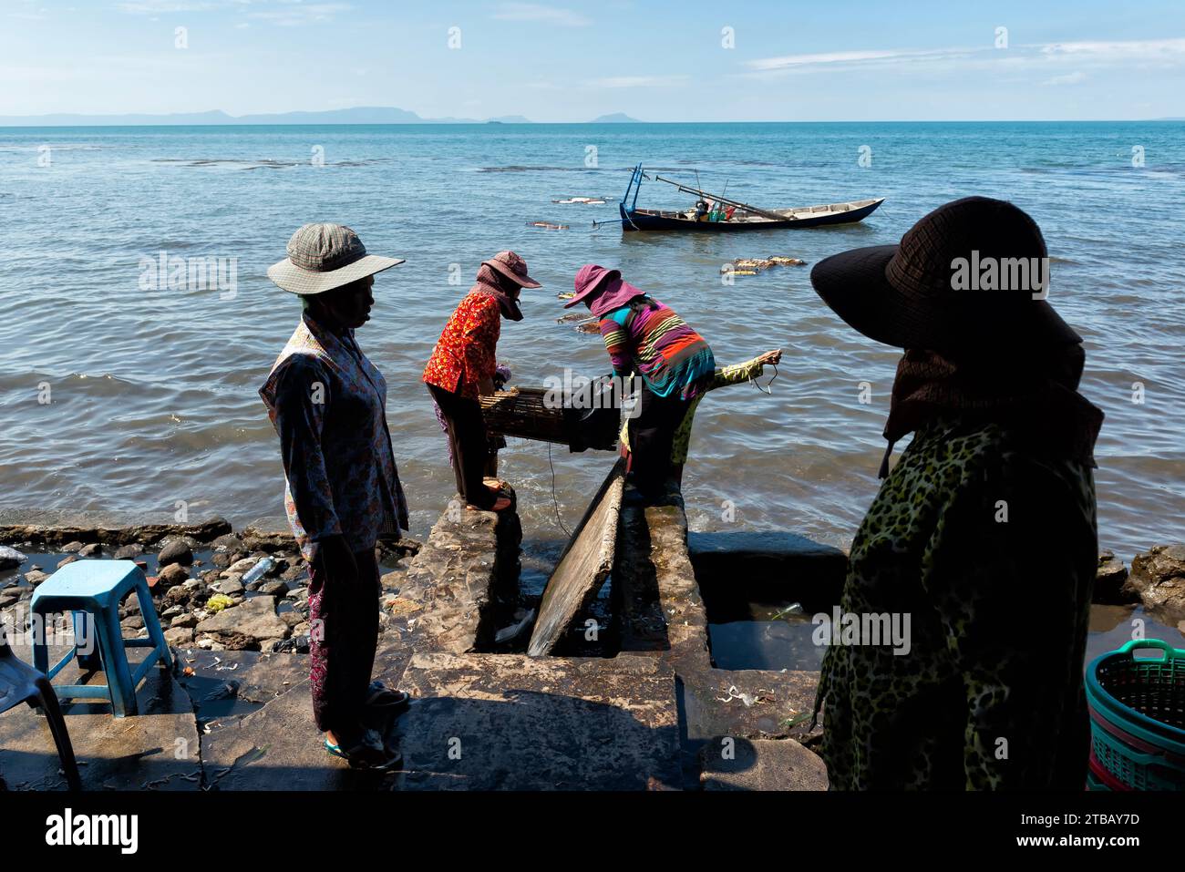 Women carrying crab traps to the Crab Market in Kep, Cambodia Stock Photo