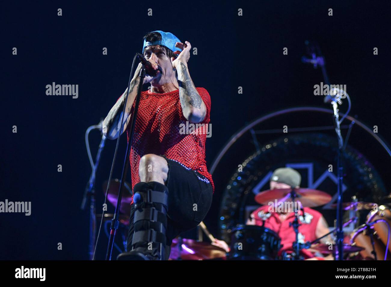 Anthony Kiedis (vocals) performing with a orthopedic walking boot. Red Hot Chili Peppers. Live