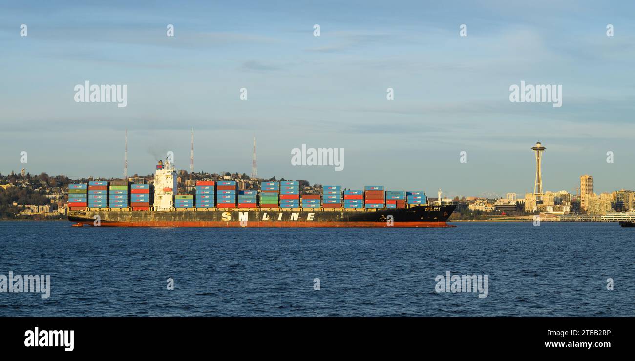 Seattle - November 20, 2023; Panorama of SM Line container ship Quingdao passing Seattle Space Needle Stock Photo
