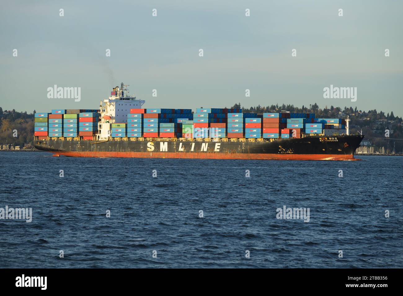Seattle - November 20, 2023; SM Line container ship Qingdao crossing Elliott Bay with name on ship Stock Photo