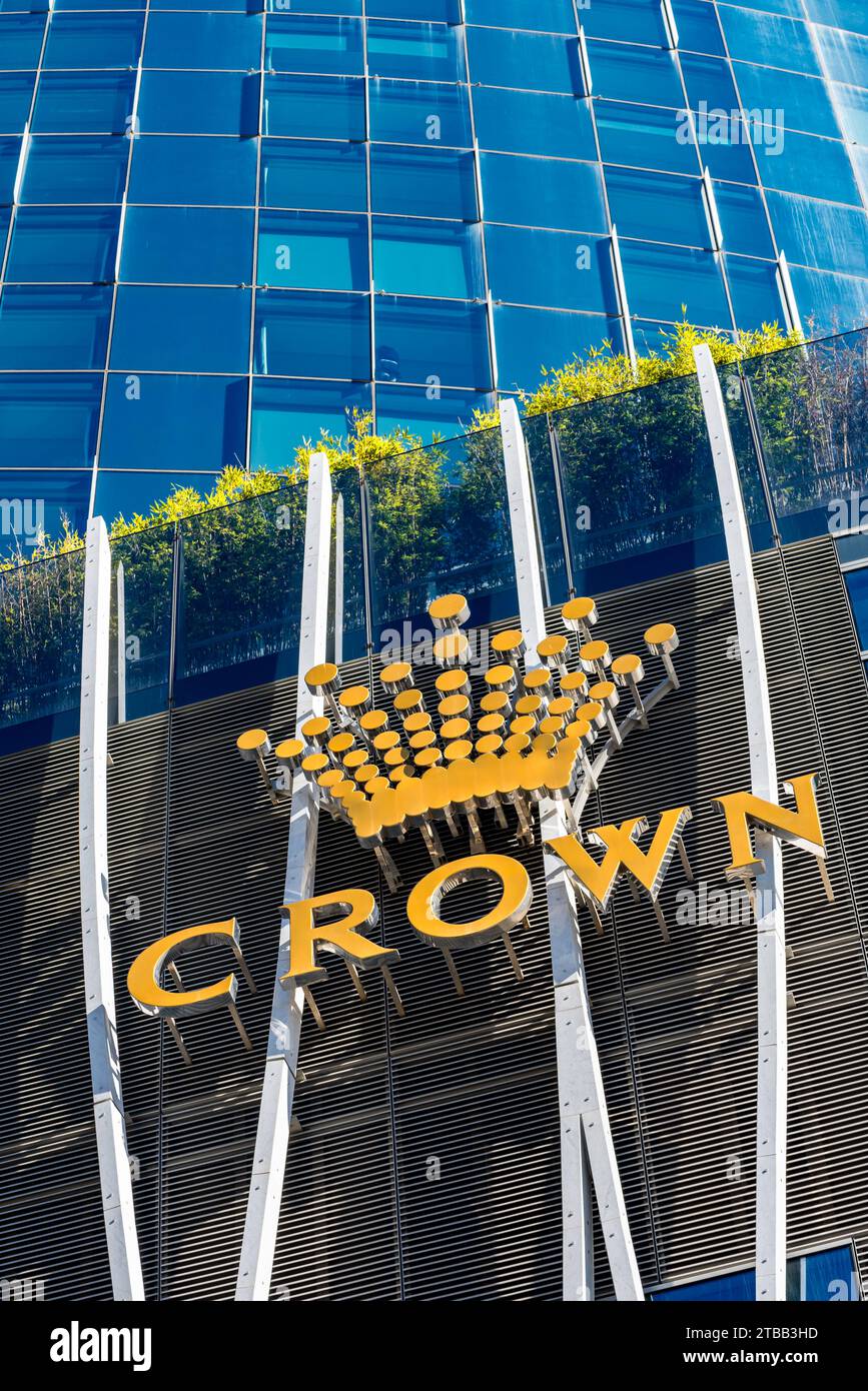 Looking up at the curved glass exterior and logo of the Crown Sydney hotel and Casino at North Barangaroo in Sydney, Australia Stock Photo