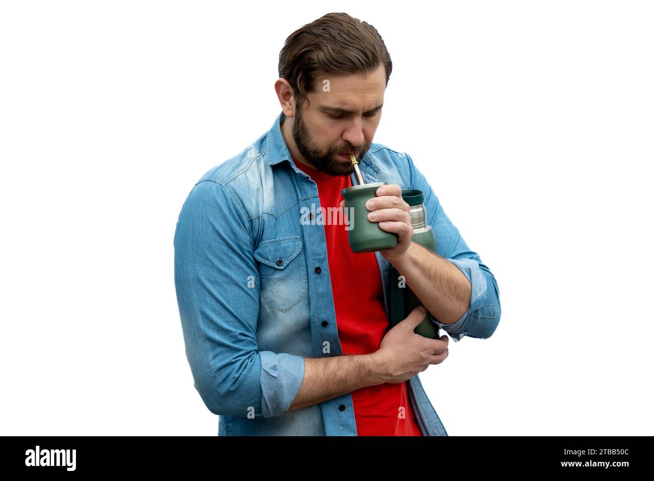 Casual young man drinking mates very seriously. Stock Photo