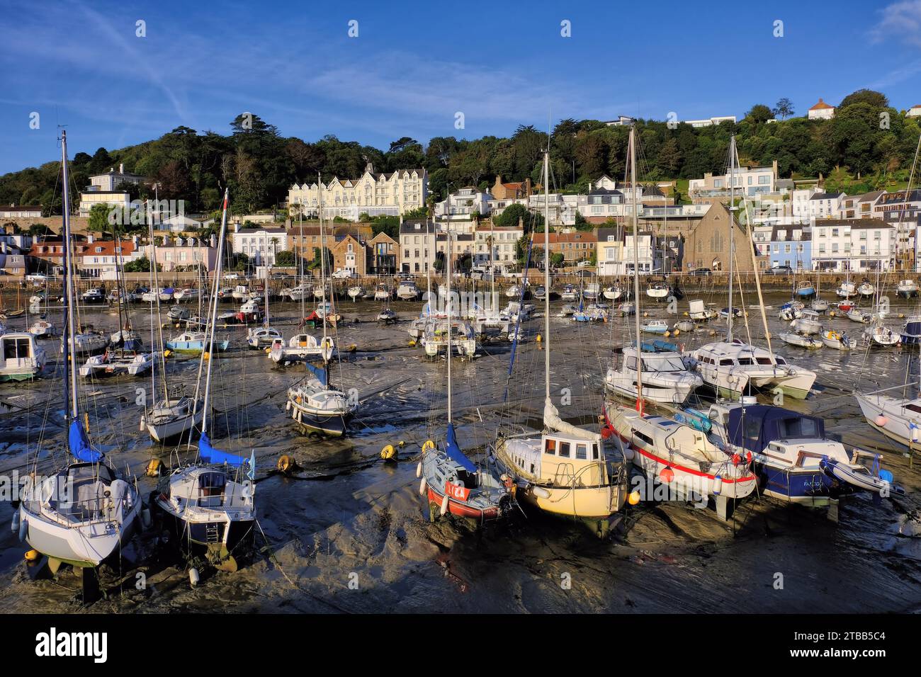 St Aubin: Yachts and boats moored in harbour, with church and Somerville Hotel in St Aubin, Channel Islands, UK Stock Photo