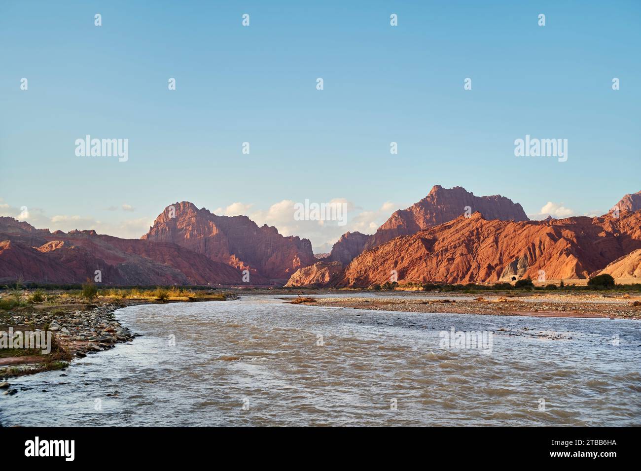 River running out of the Tianshan Mysterious Grand Canyon at sunset in Xinjiang, China Stock Photo