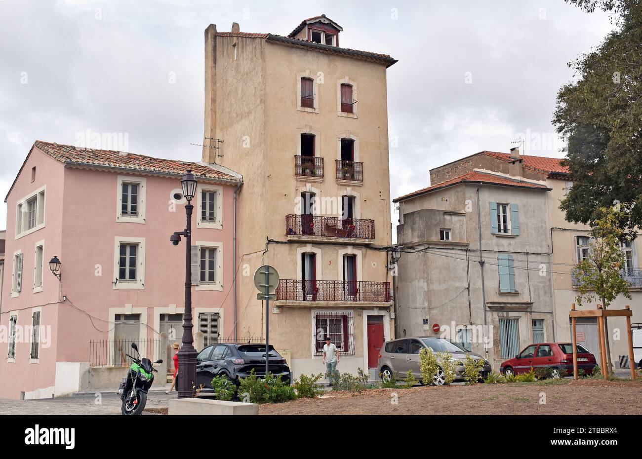 An odd assortment of notably unattractive houses facing Beziers cathedral, one possibly extended upwards at least twice, probably dangerously Stock Photo