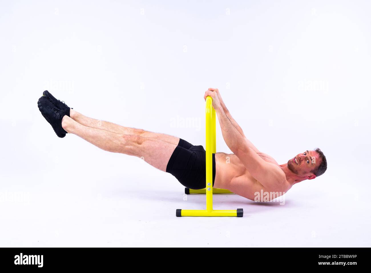 Parallel Action Shot Male gymnast performing handstand on parallel bars, studio shot Stock ...