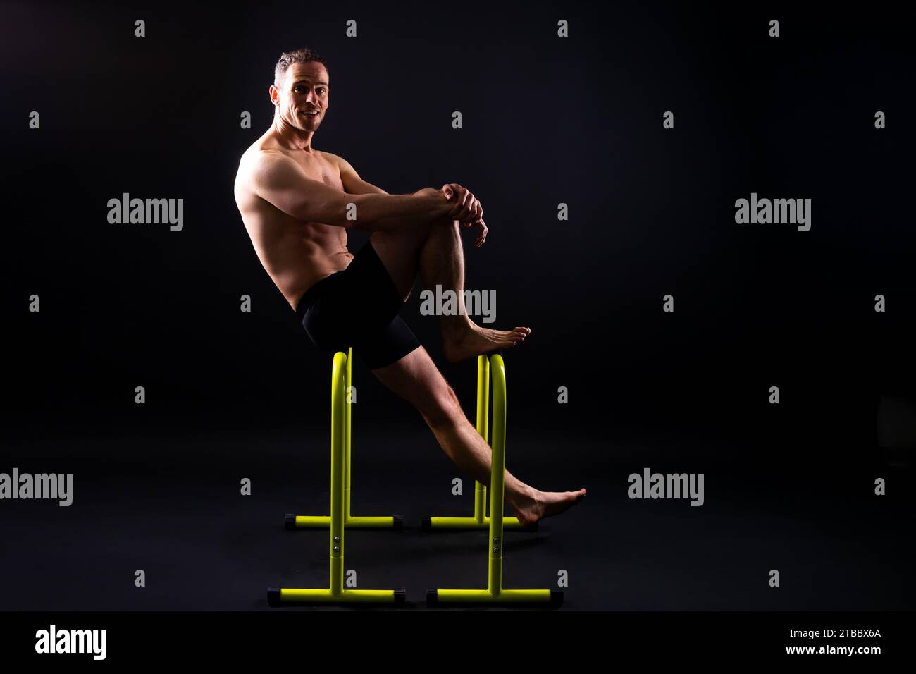 Parallel Action Shot Male gymnast performing handstand on parallel bars, studio shot Stock ...