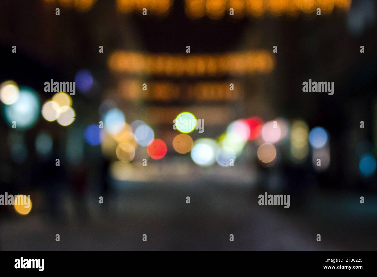 downtown street at night. winter holiday shopping season blurry background. bokeh effect Stock Photo