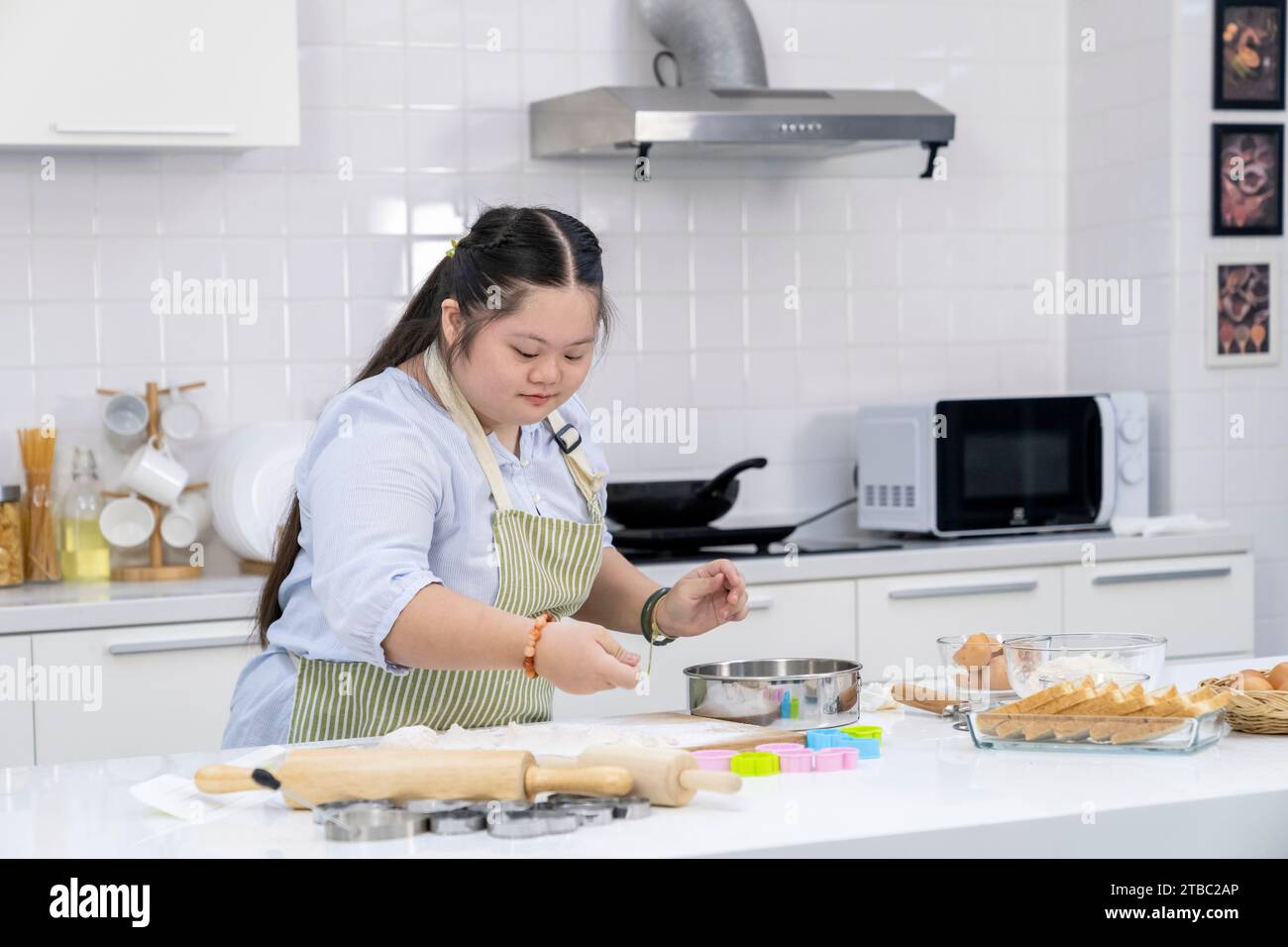 A girl practicing cooking in the kitchen at home Stock Photo - Alamy