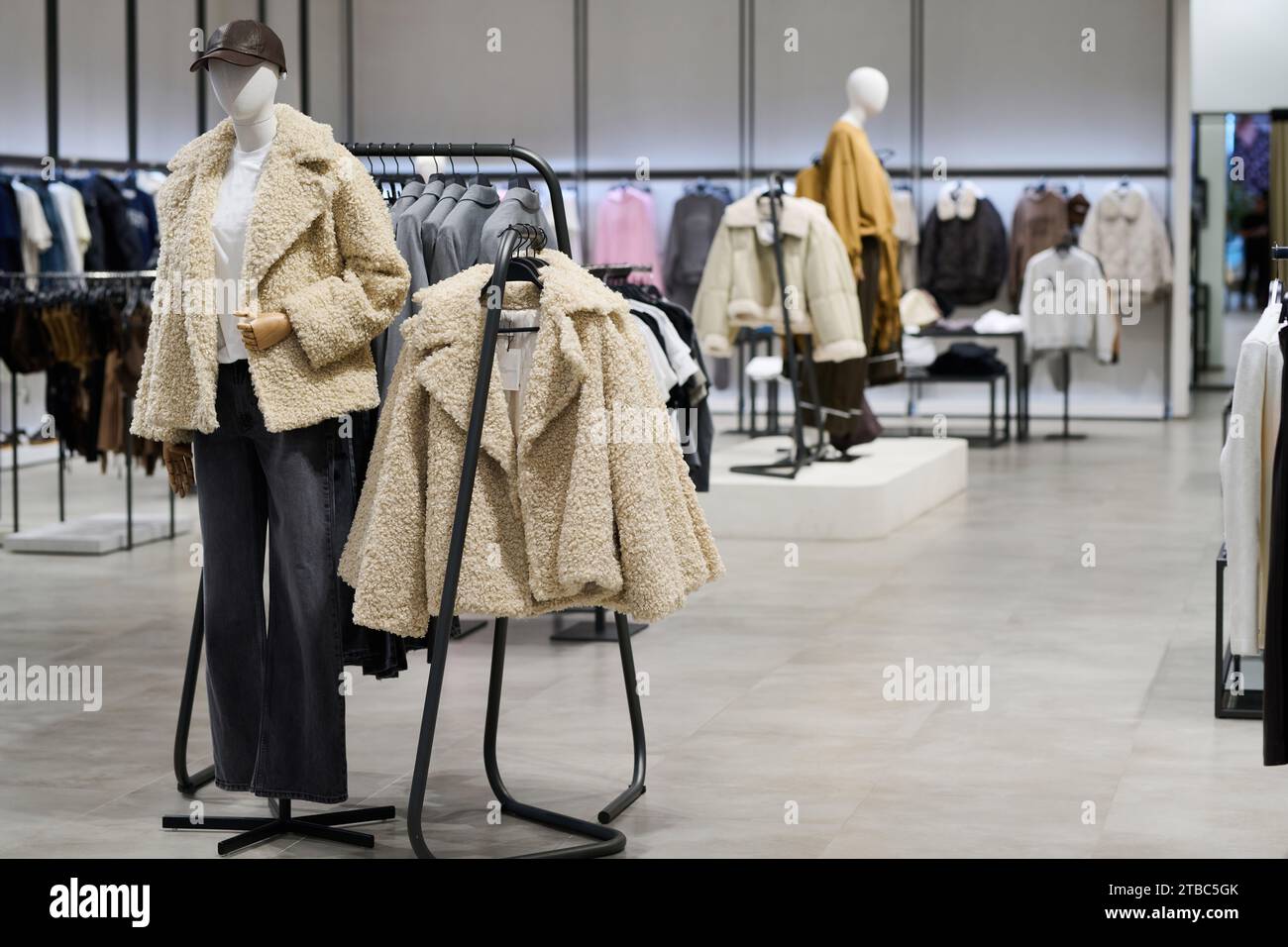 Wide shot of youth clothing store interior in shopping center Stock