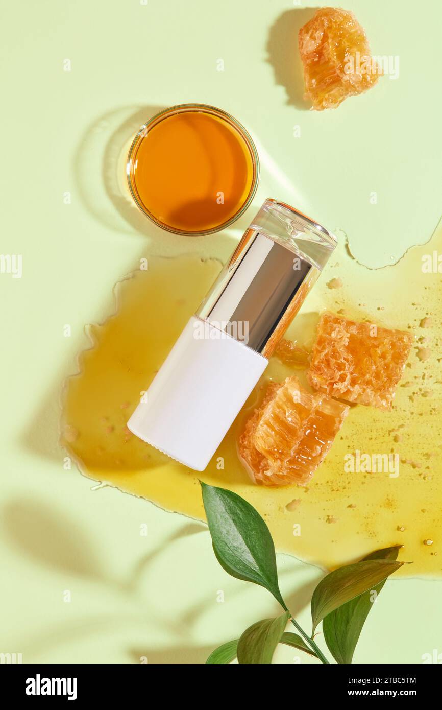 Some beeswax displayed with a petri dish of honey and a bottle without