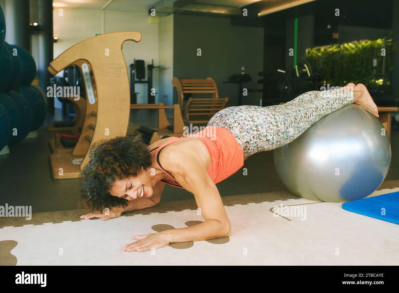 Portrait of mature 50 55 year old woman traing with fitness ball at gym, healthy lifestyle