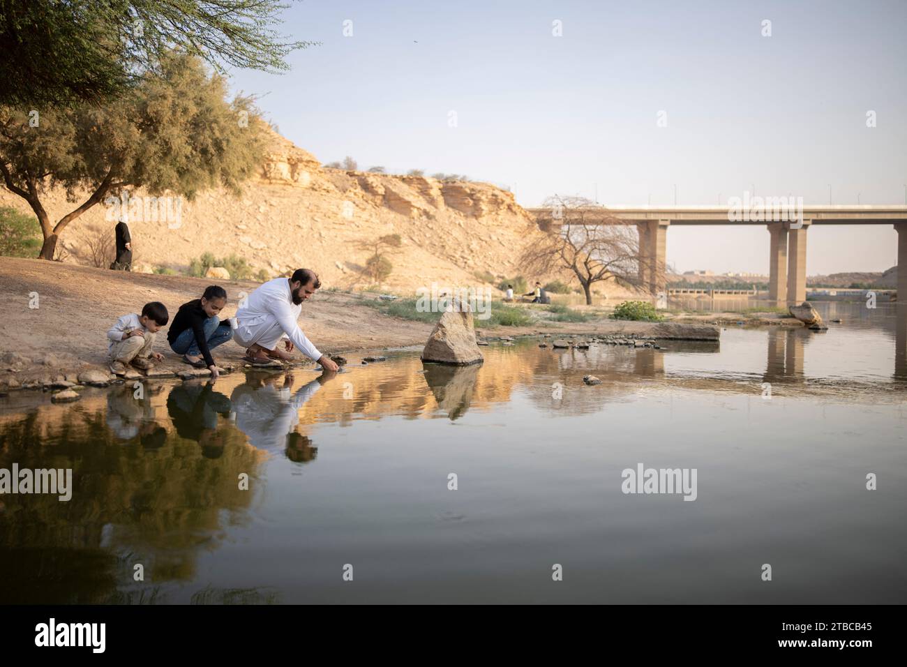 Daily life at Wadi Hanifa in Riyadh, Saudi Arabia on October 15, 2022, during the Noor Riyadh Festival 2022. Wadi Hanifa, historically known as Wadi al-Arad, is a wadi (seasonal river) in the Najd region, Riyadh Province, in central Saudi Arabia. The valley runs for a length of 120 km from northwest to southeast, cutting through the city of Riyadh. A string of towns and villages lie along the valley, including Uyaynah, Irqah and Diriyah. The historical city of Riyadh itself is on the northeastern side of the wadi, but the city has now expanded across Wadi Hanifa, with the sub-municipalities of Stock Photo