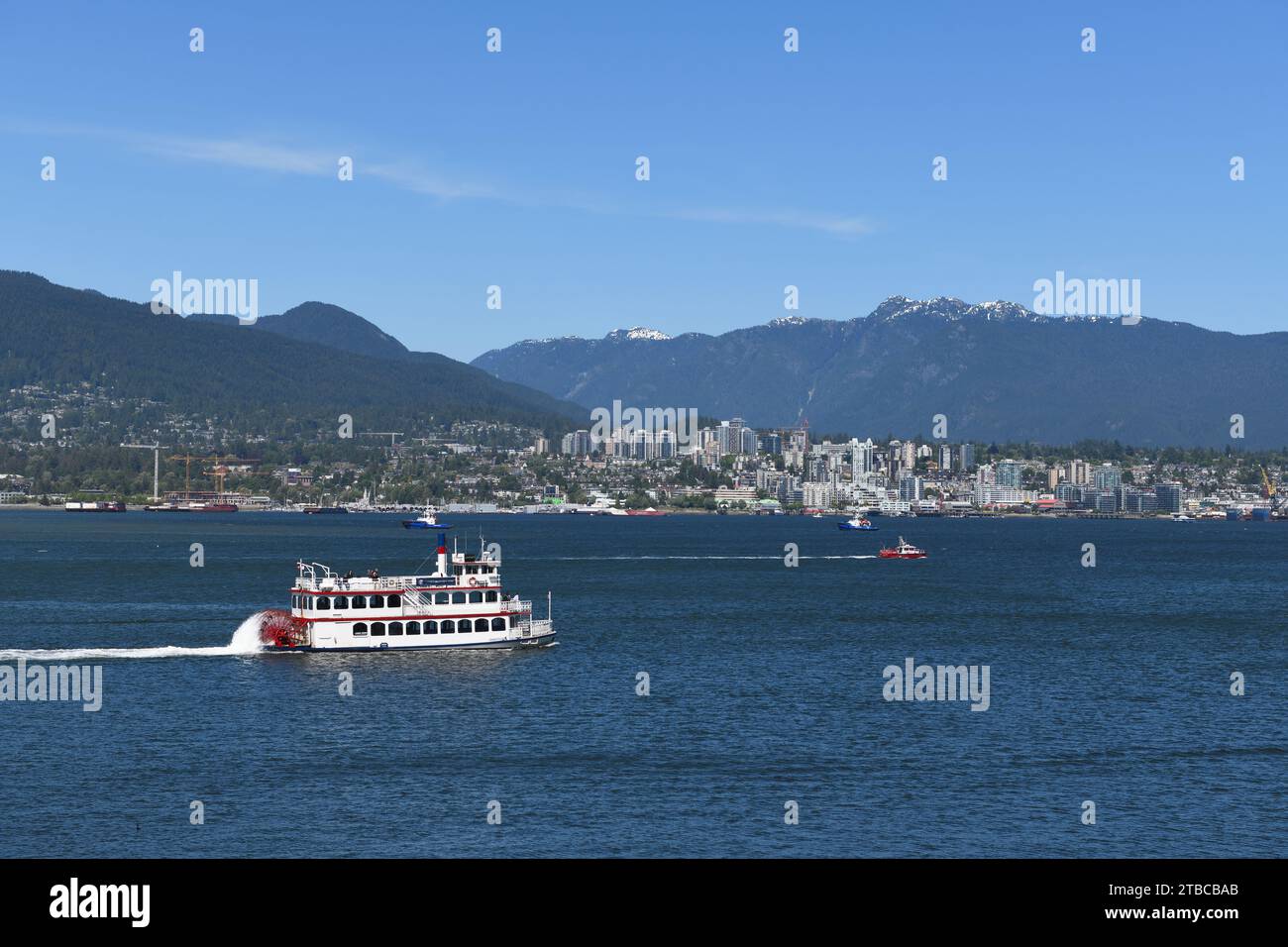 A paddle streamer passenger ferry crossing the  bay towards North Vancouver Stock Photo