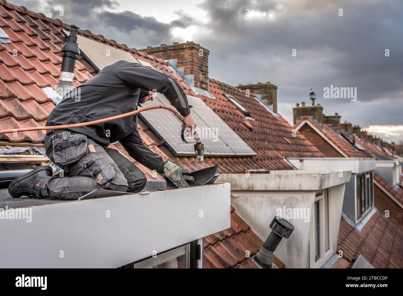 VOORBURG A roofer is carrying out repair work. Due to storms and