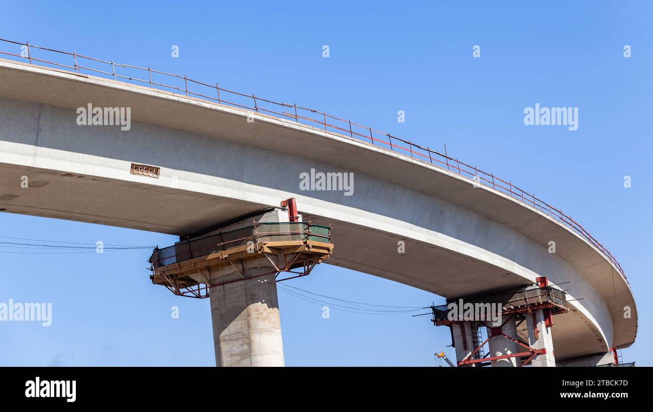New Road Highway junction inter section entry exit ramp elevated  concrete moulded structure closeup section upward photograph . Stock Photo