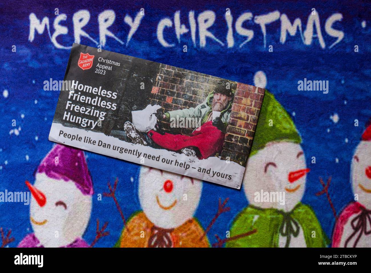 Post mail on Merry Christmas doormat - Christmas appeal 2023 from the Salvation Army, homeless friendless freezing hungry Stock Photo