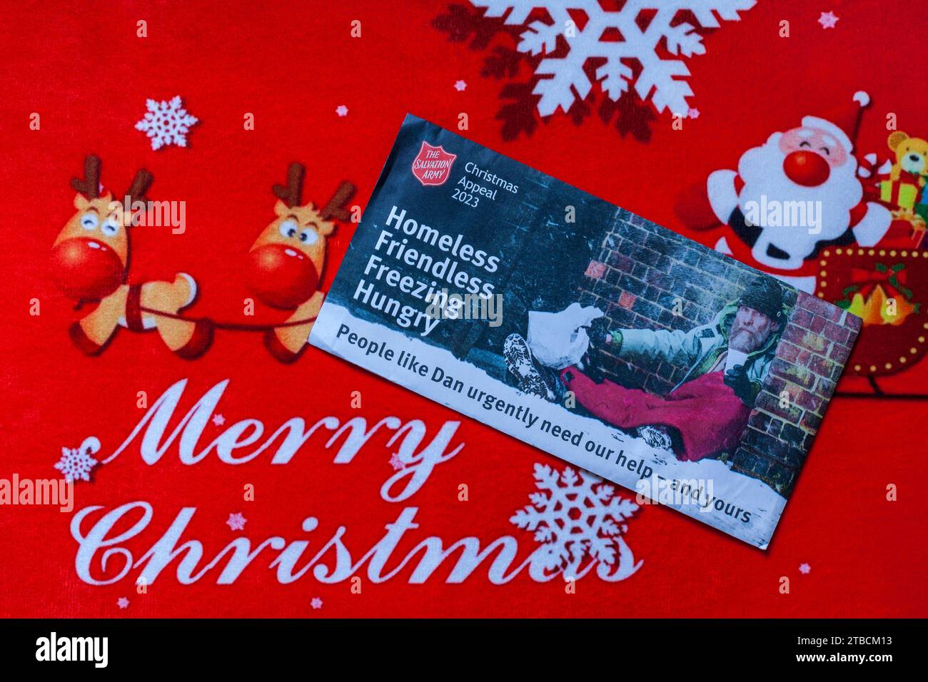 Post mail on Merry Christmas doormat - Christmas appeal 2023 from the Salvation Army, homeless friendless freezing hungry Stock Photo