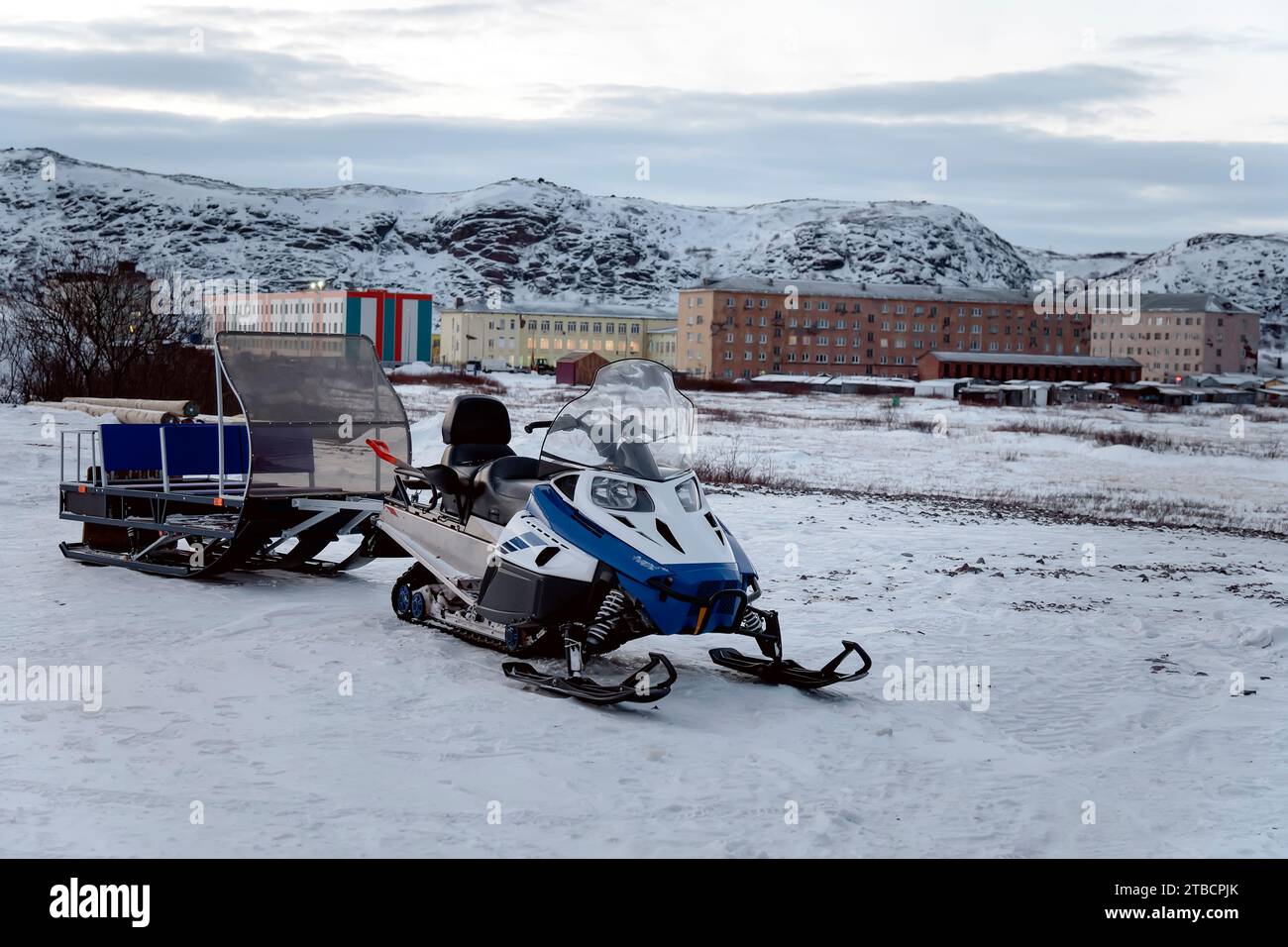 a snowmobile with a trailer for transporting tourists in the village of Teriberka, Russia, Kola poluostrov. Stock Photo