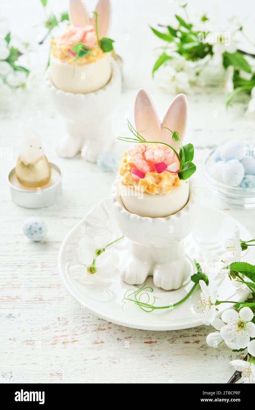 Stuffed or deviled eggs with yolk, shrimp, pea microgreens with paprika ...