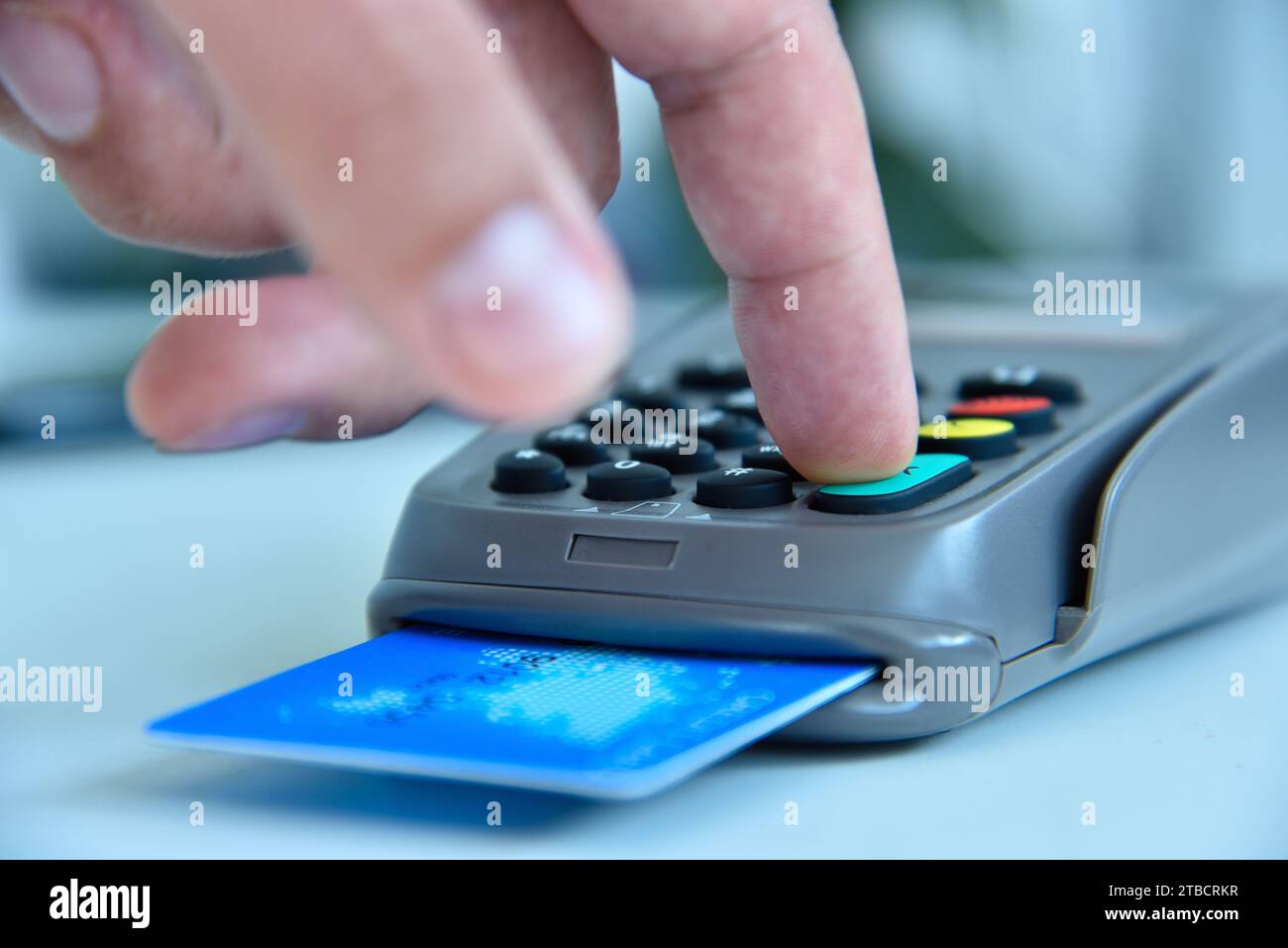 Hand dials pin code on pos terminal with credit card. Payment with