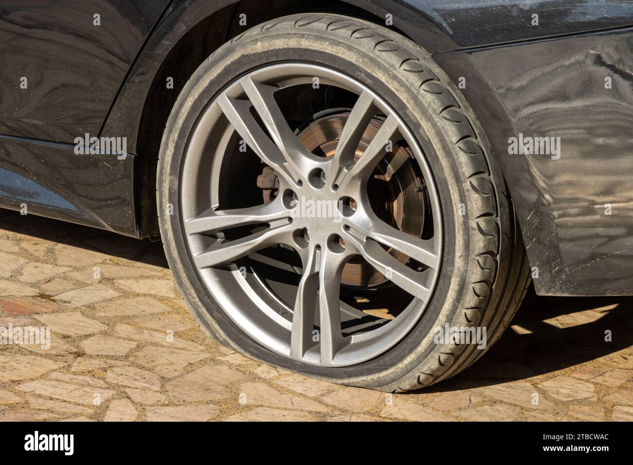 Burst flat car tire wheel. On a car Stock Photo
