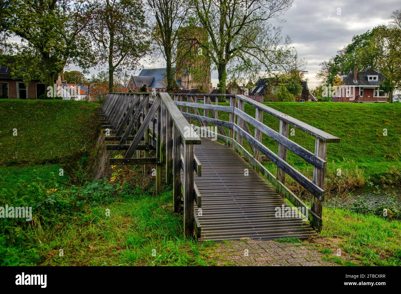 Woudrichem, The Netherlands, November 8, 2023: wooden bridge for pedestrians crossing the moat which is part of the towns fortifications Stock Photo