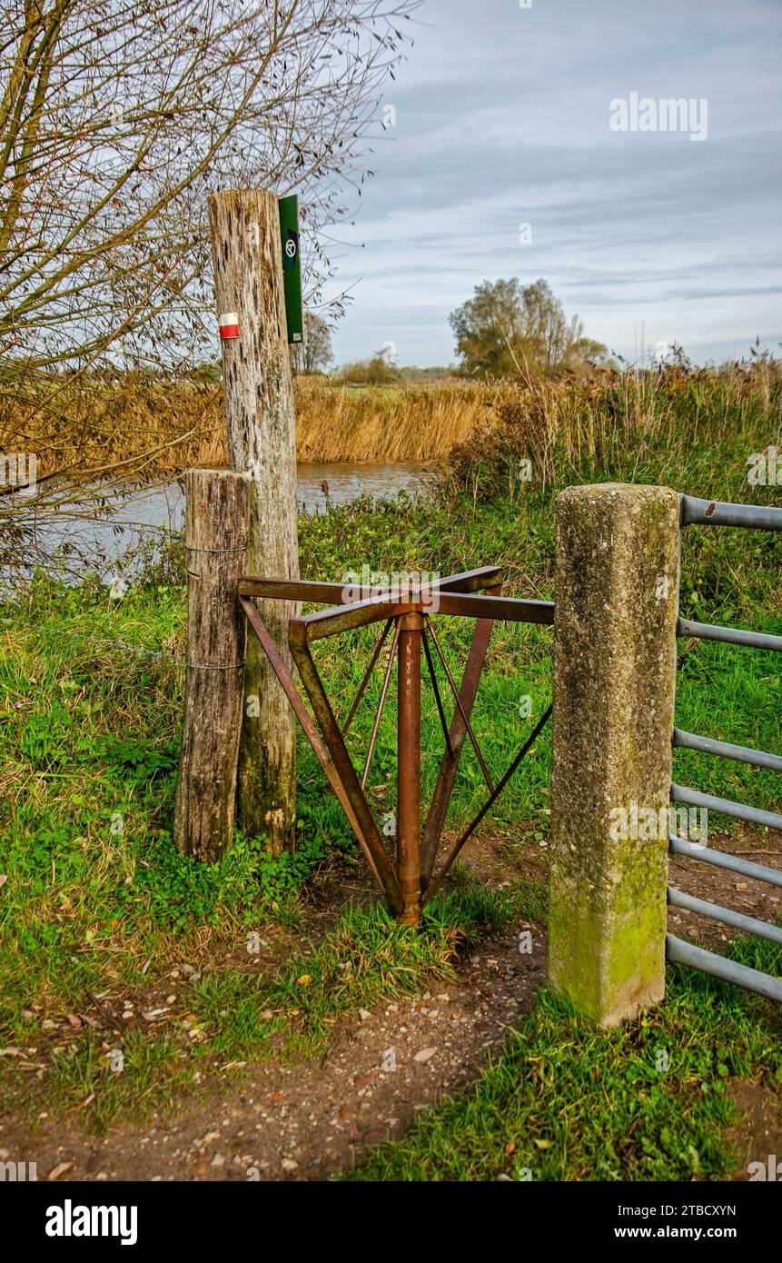 Woudrichem, The Netherlands, November 8, 2023: steel wood and concrete as part of a fence with a rotating element as part of a hiking trail Stock Photo
