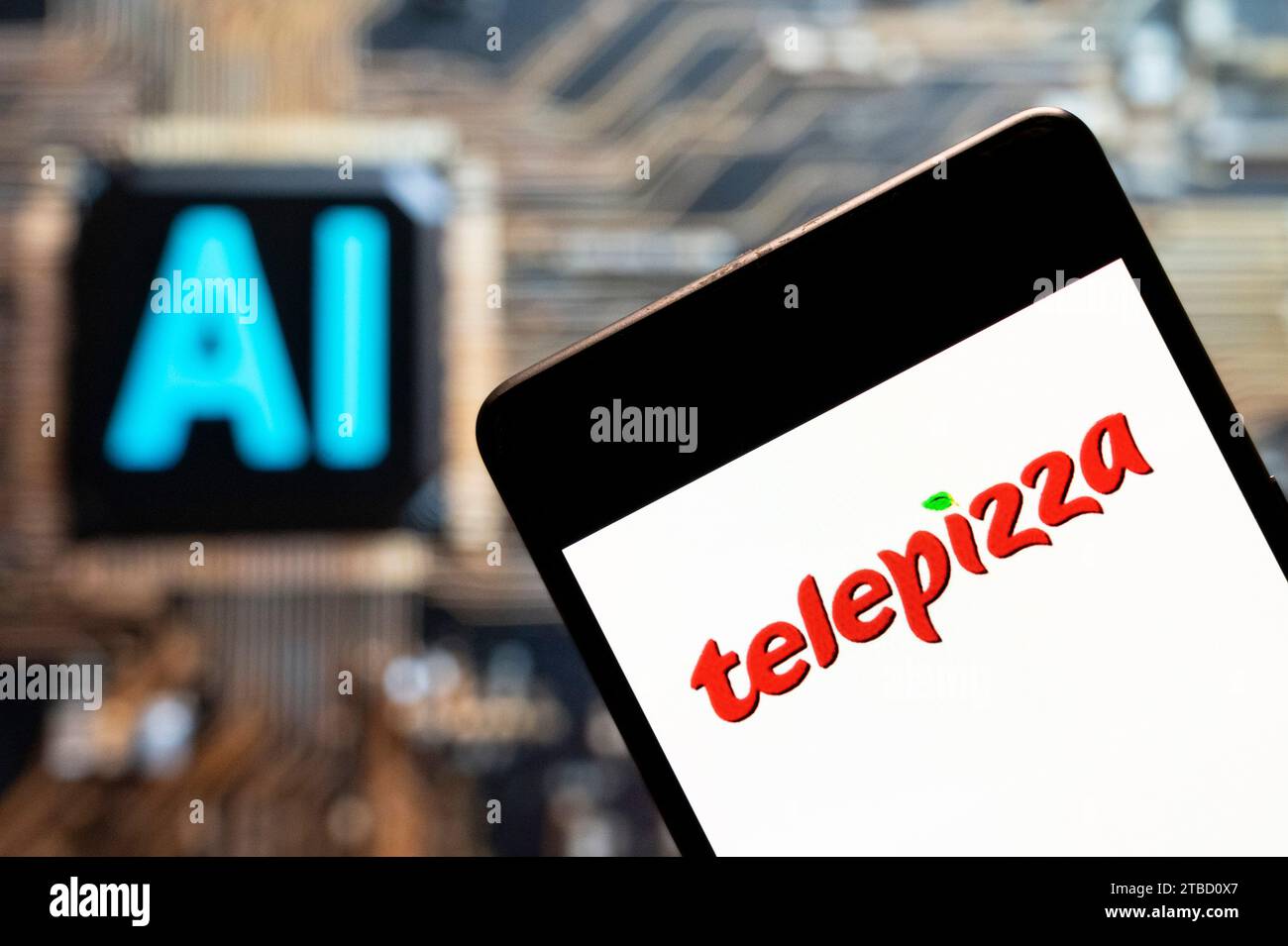 In this photo illustration, the Spanish pizza restaurant franchise Telepizza logo seen displayed on a smartphone with an Artificial intelligence (AI) chip and symbol in the background. Stock Photo