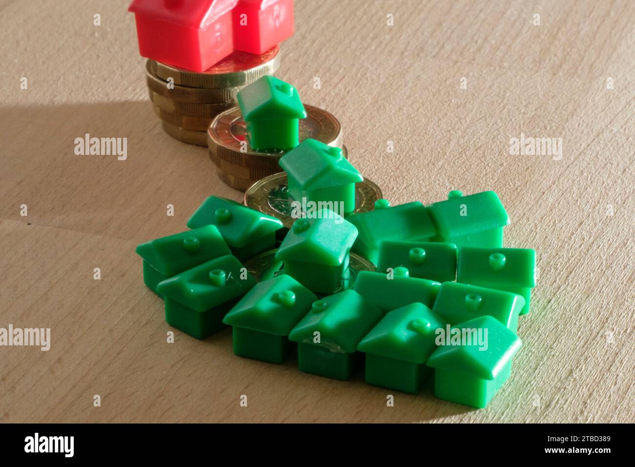 Financial Concept. Monopoly houses and cash, money, loans, mortgages , pension and debt. Small People Stock Photo