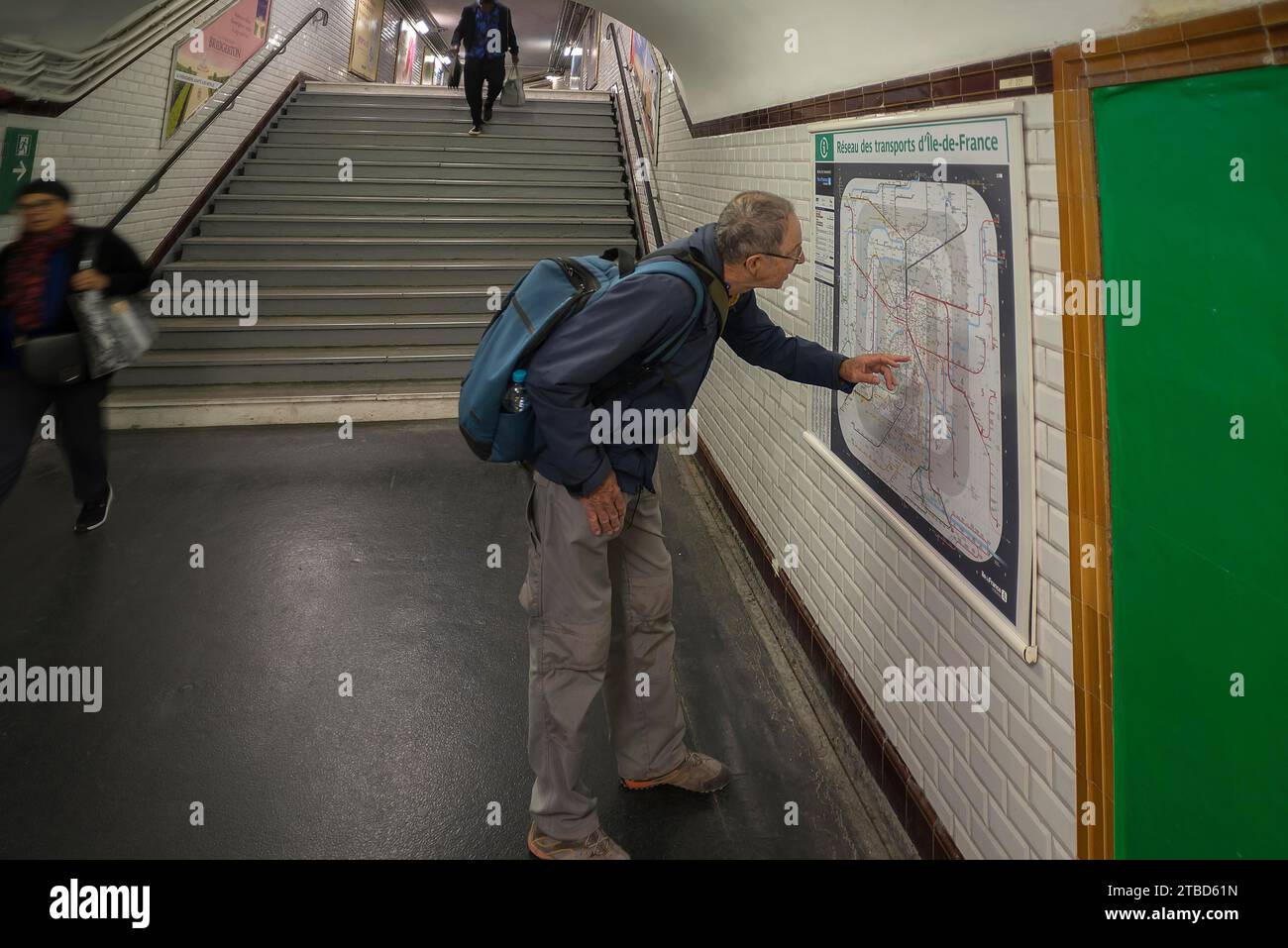 Elderly gentleman orientates himself on the map in the Metro, Paris, France Stock Photo