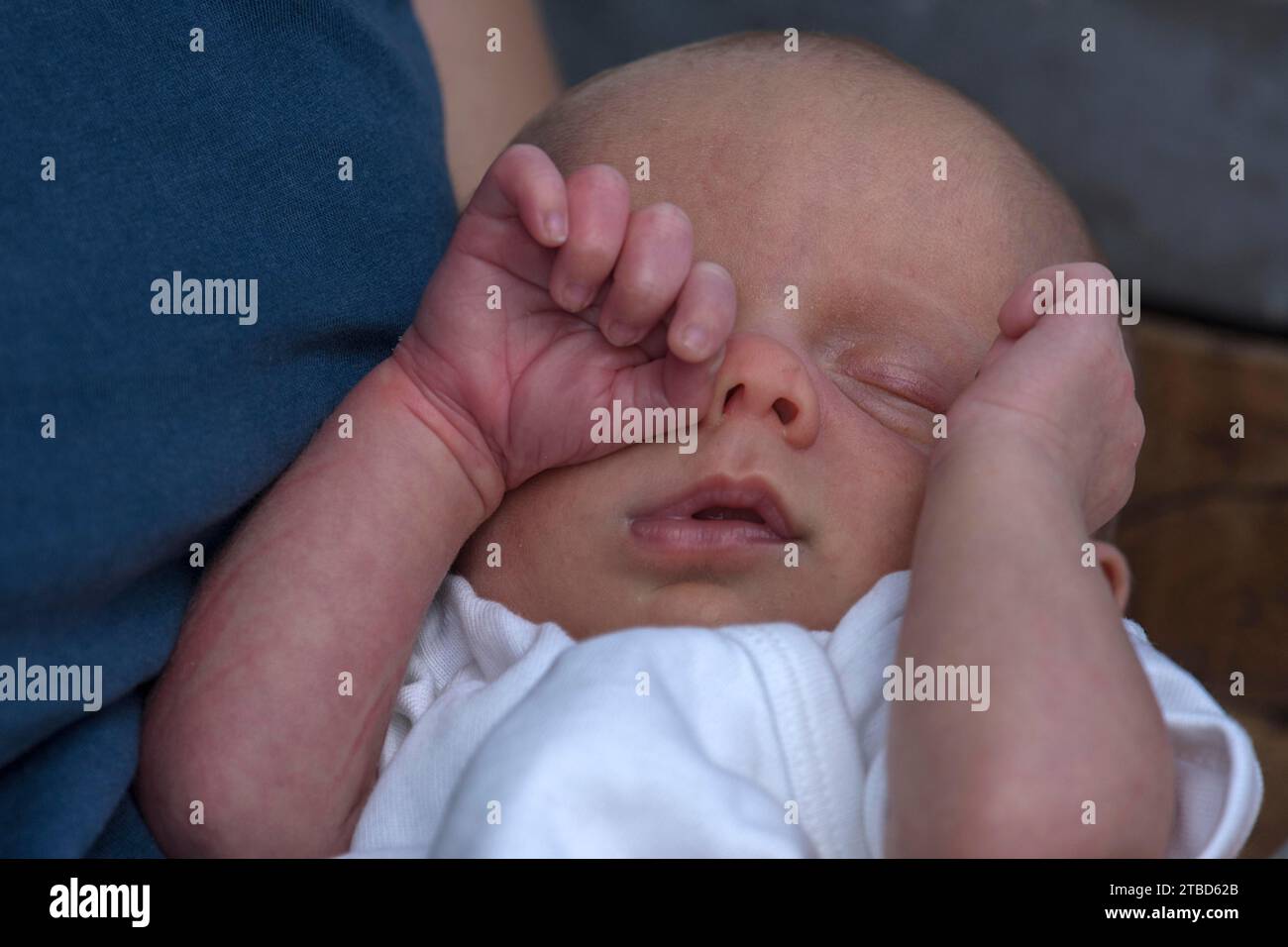 Infant rubbing his eye with his hand, Mecklenburg-Vorpommern, Germany Stock Photo
