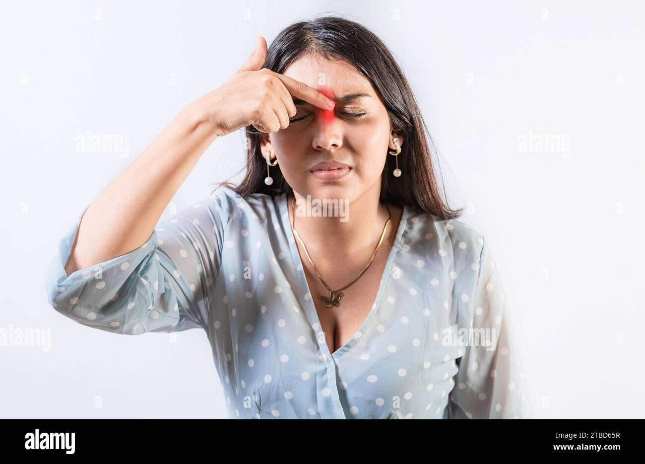 Person with nasal bridge pain, Girl with nasal bridge headache. Sinus pain concept. Young woman with pain touching nose Stock Photo
