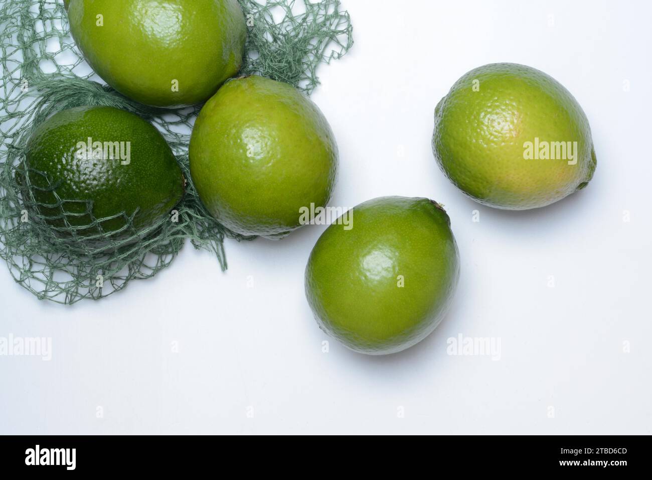 Limes with packing net, citrus fruits Stock Photo Alamy