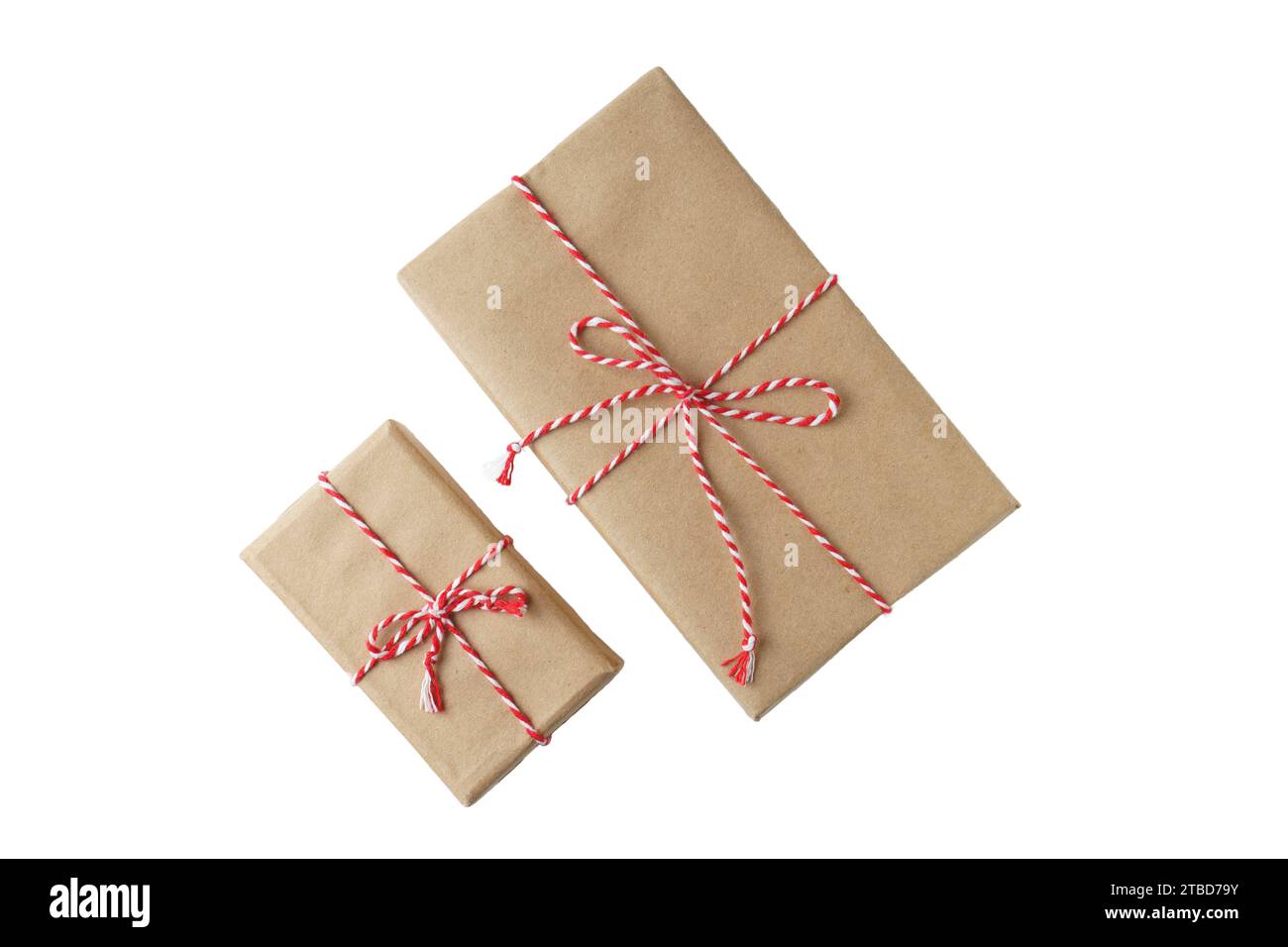 Gift box Wrapped in Brown Recycled Paper with White Ribbon Bow Top View  with Fir Branches. Christmas Concept. Close Up. Stock Photo