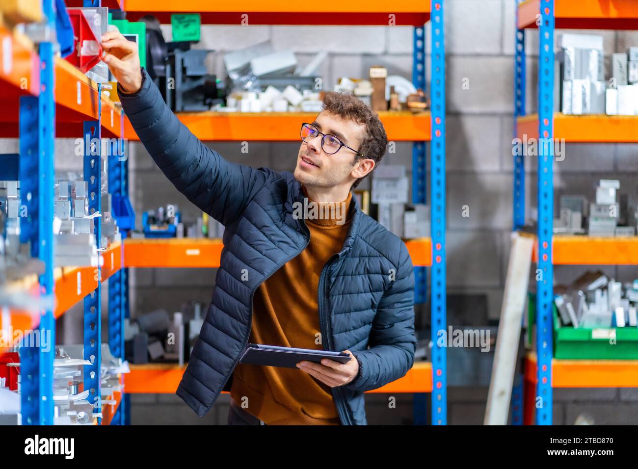 Engineer using tablet in the stock room of a computer numeric control modern factory Stock Photo